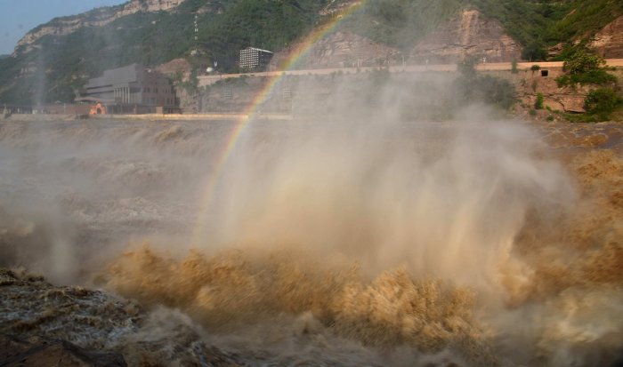 Flood water pounding against a canyon wall